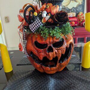 Holiday flower arrangement with realistic pumkin